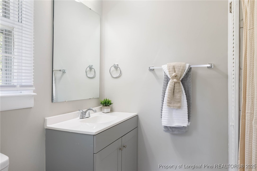 2419 Morganton Road Fayetteville, NC 28303 - Photo 30 of 44 a bathroom with a sink and mirror