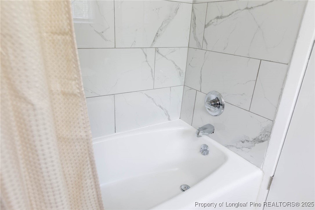 2419 Morganton Road Fayetteville, NC 28303 - Photo 32 of 44 a white bath tub sitting in a bathroom