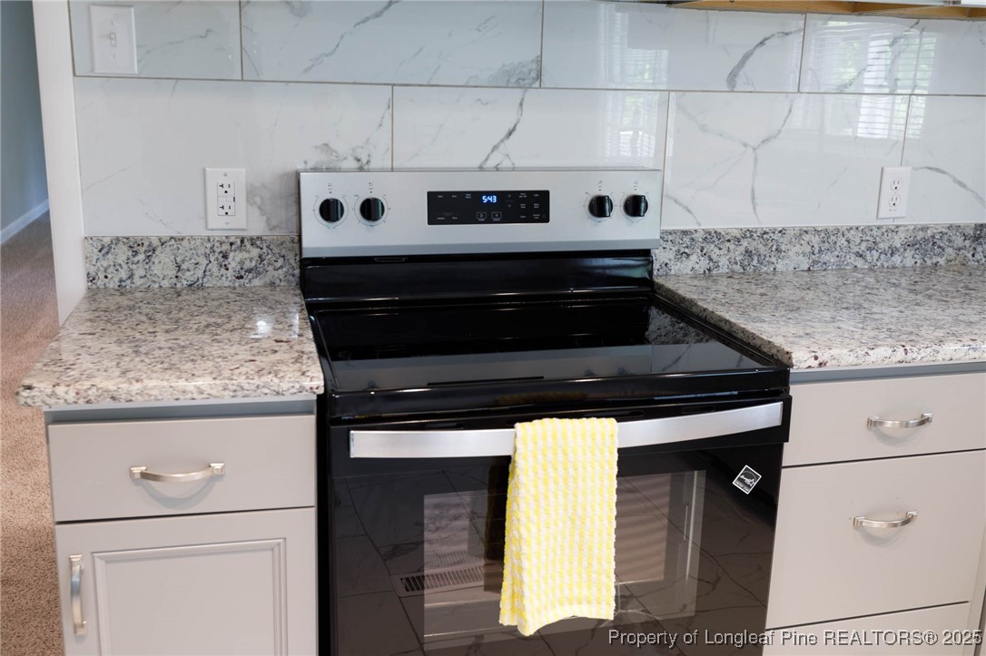 2419 Morganton Road Fayetteville, NC 28303 - Photo 9 of 44 a kitchen with granite countertop cabinets and stove top oven