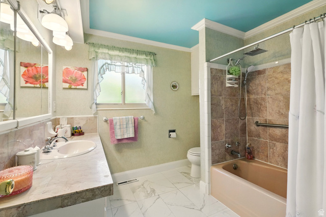 1188 600 East Logan, UT 84341 - Photo 15 of 16 Full bathroom featuring vanity, shower / bath combo with shower curtain, ornamental molding, and light marble finish flooring