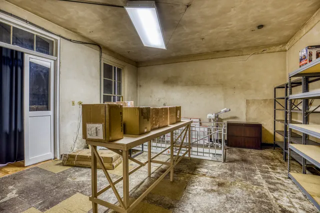a balcony with chairs and book shelf