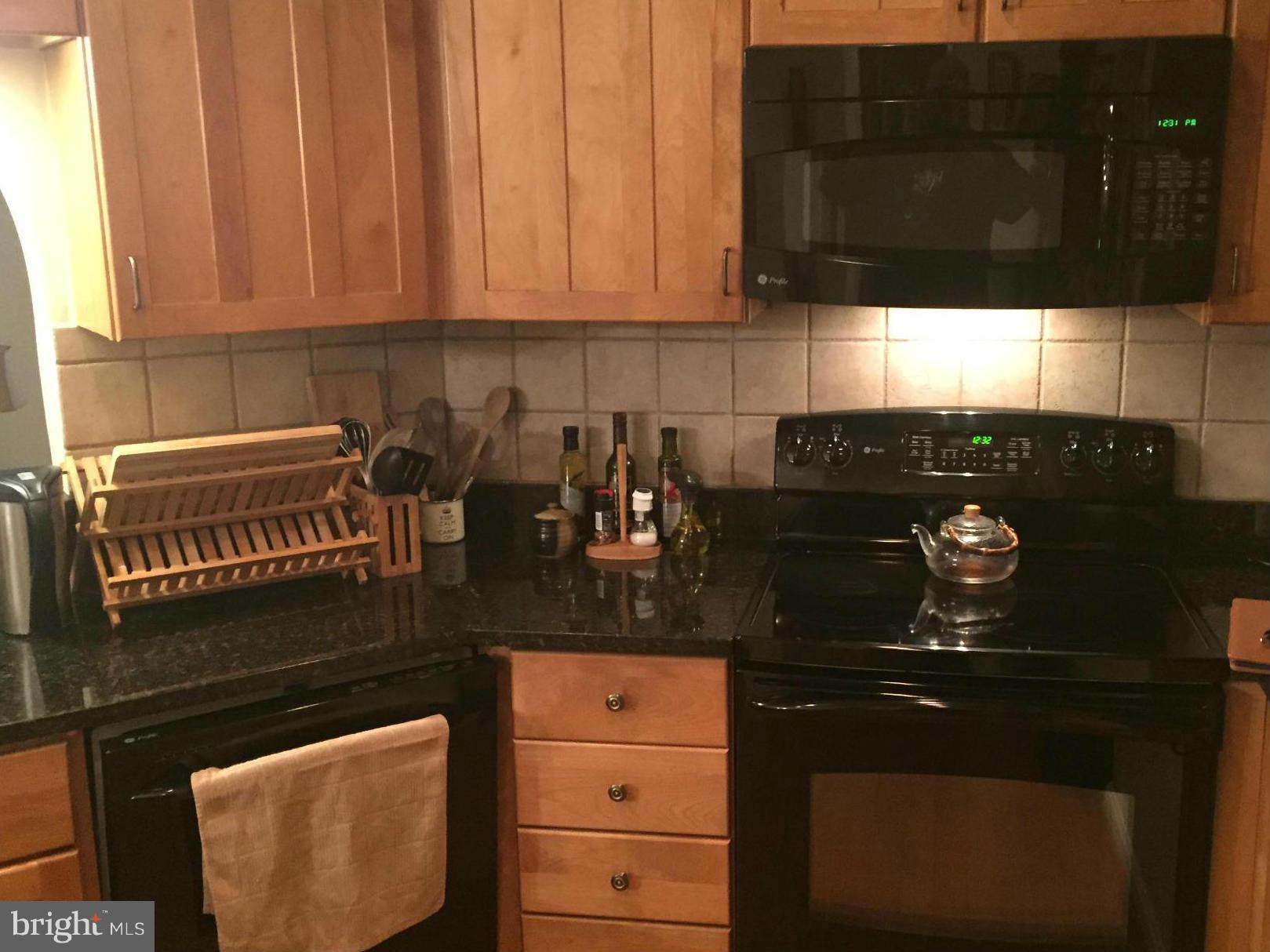 11286 Harbor Court, Unit 11286 Reston, VA 20191 - Photo 2 of 27 a kitchen with a sink and cabinets