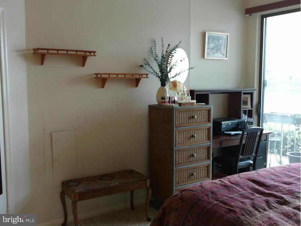 11286 Harbor Court, Unit 11286 Reston, VA 20191 - Photo 17 of 27 a bedroom with a bed and a chandelier