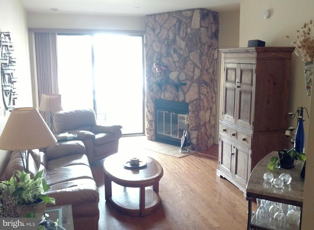 11286 Harbor Court, Unit 11286 Reston, VA 20191 - Photo 19 of 27 a living room with furniture and wooden floor