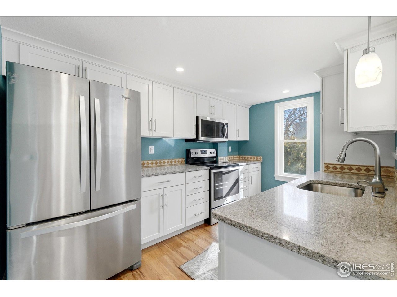 1812 Rice Street Longmont, CO 80501 - Photo 14 of 44 a kitchen with stainless steel appliances granite countertop a refrigerator sink and stove