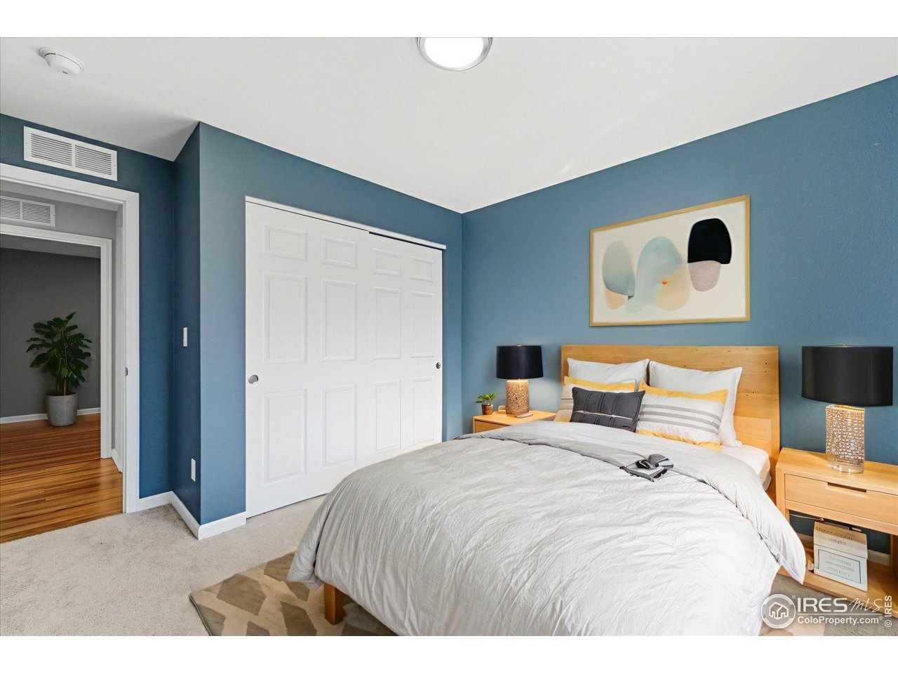 1812 Rice Street Longmont, CO 80501 - Photo 18 of 44 a bedroom with a bed and lamp