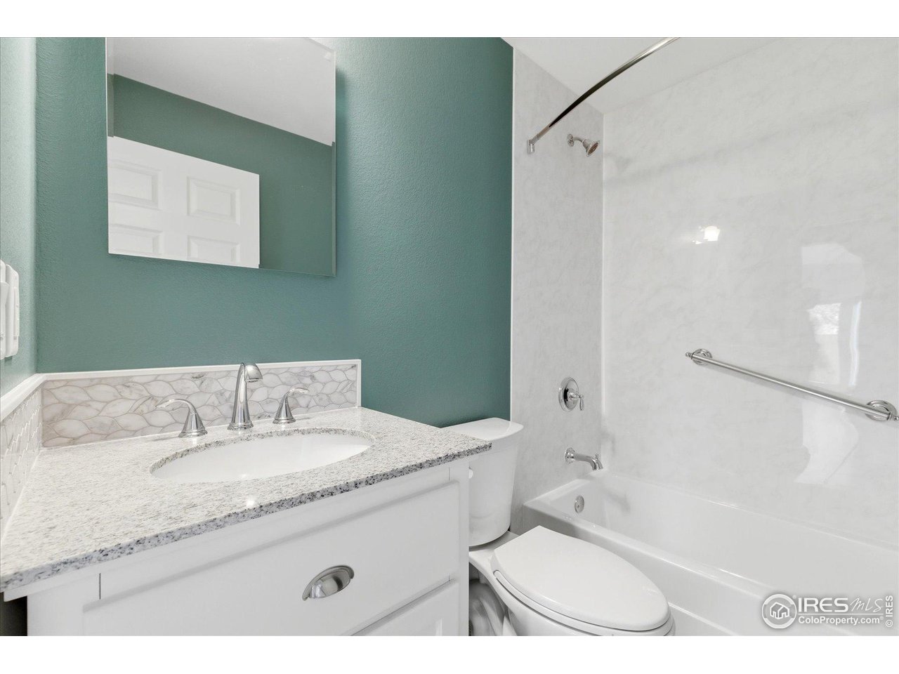 1812 Rice Street Longmont, CO 80501 - Photo 20 of 44 a bathroom with a granite countertop sink a mirror and a bathtub