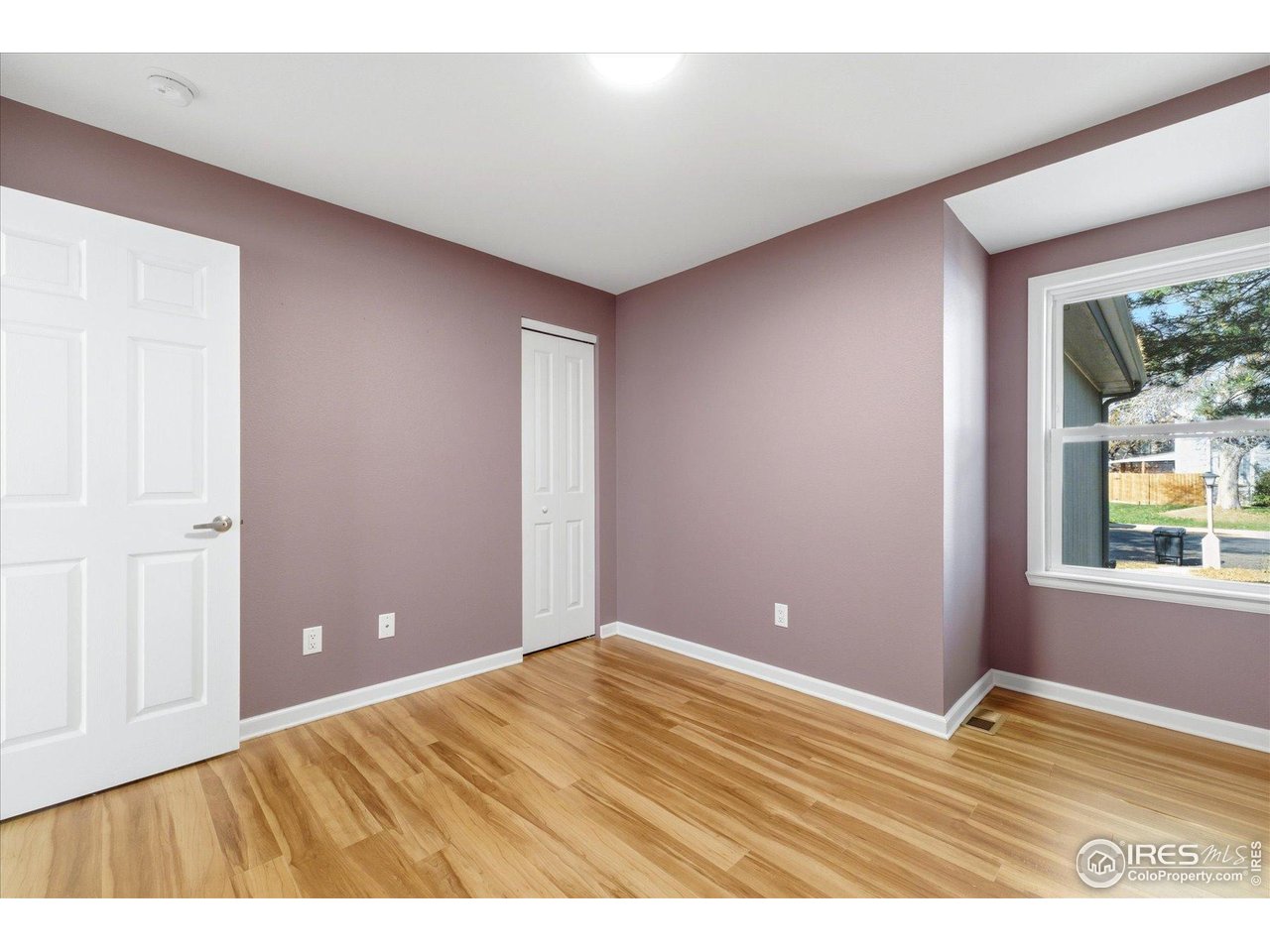 1812 Rice Street Longmont, CO 80501 - Photo 24 of 44 a view of empty room with window and wooden floor
