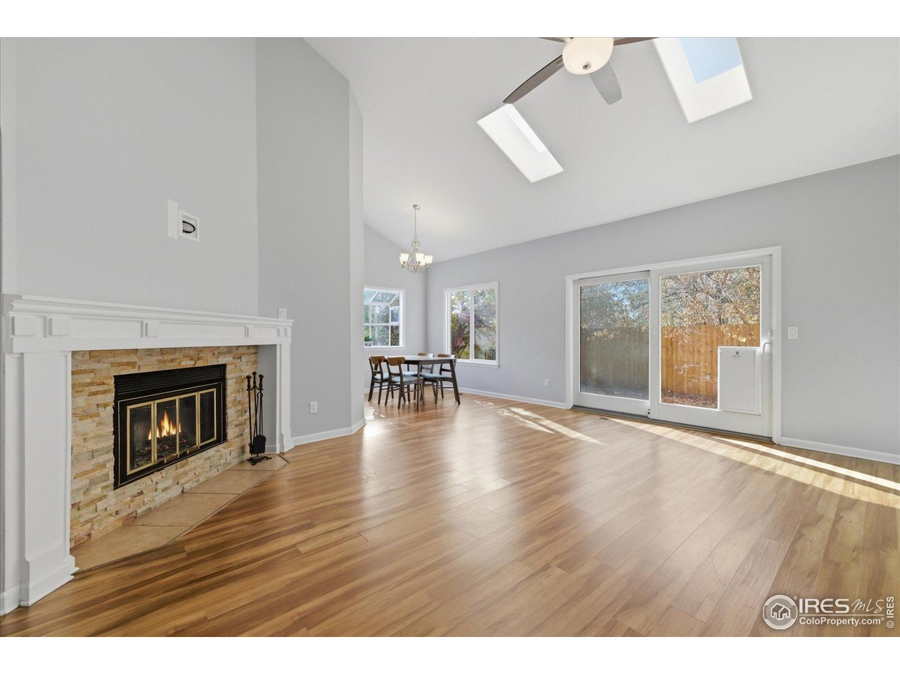 1812 Rice Street Longmont, CO 80501 - Photo 8 of 44 a view of an empty room with wooden floor and a fireplace