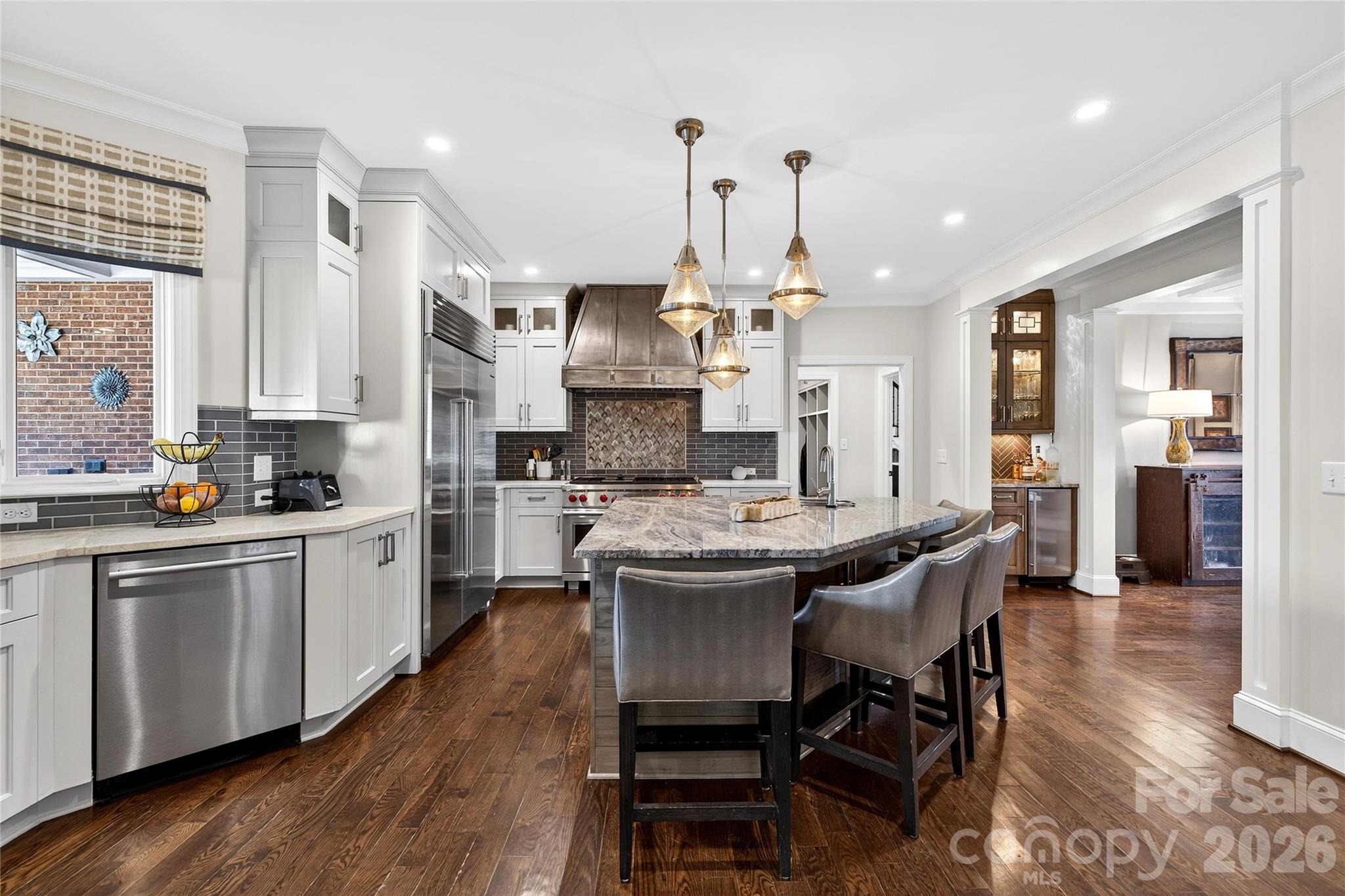 3025 Foxridge Road Charlotte, NC 28226 - Photo 14 of 48 a kitchen with stainless steel appliances a table chairs sink and cabinets