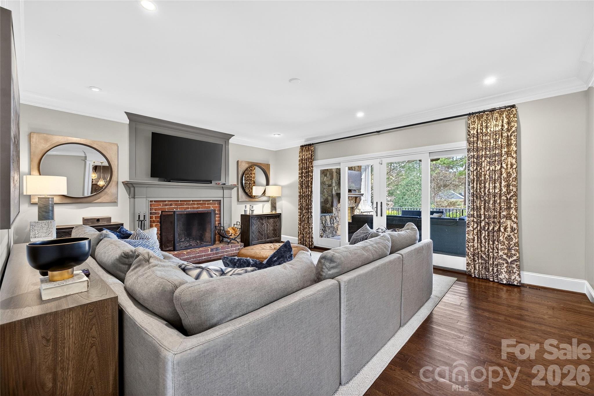 3025 Foxridge Road Charlotte, NC 28226 - Photo 18 of 48 a living room with furniture a fireplace and a flat screen tv