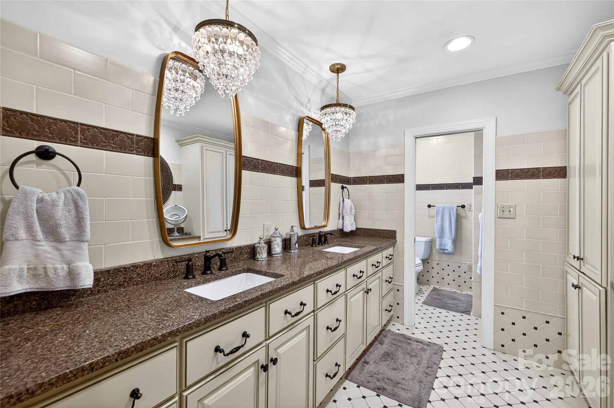 3025 Foxridge Road Charlotte, NC 28226 - Photo 34 of 48 a bathroom with double vanity sink and a mirror