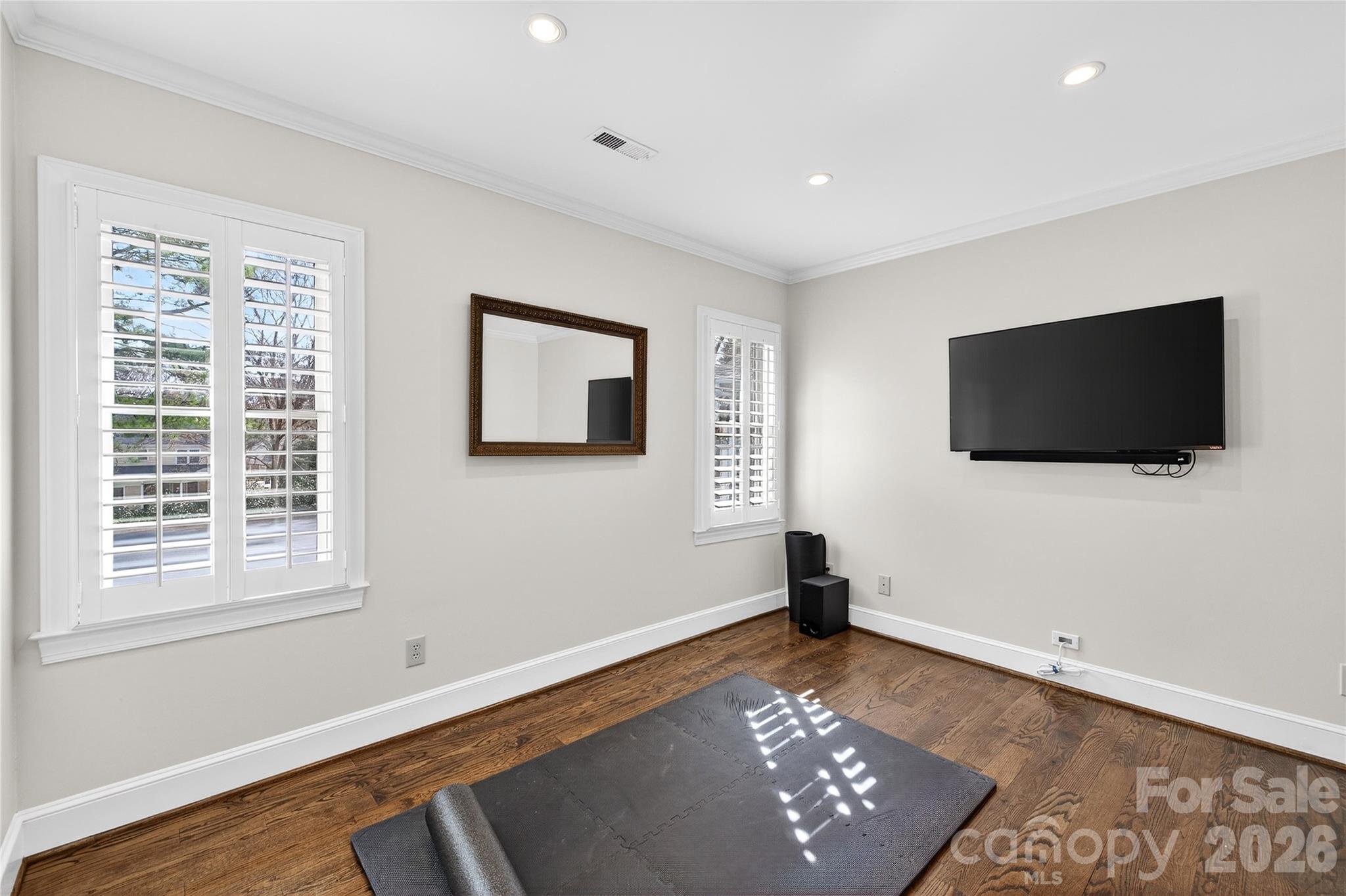 3025 Foxridge Road Charlotte, NC 28226 - Photo 37 of 48 a view of an empty room with a flat screen tv and a window
