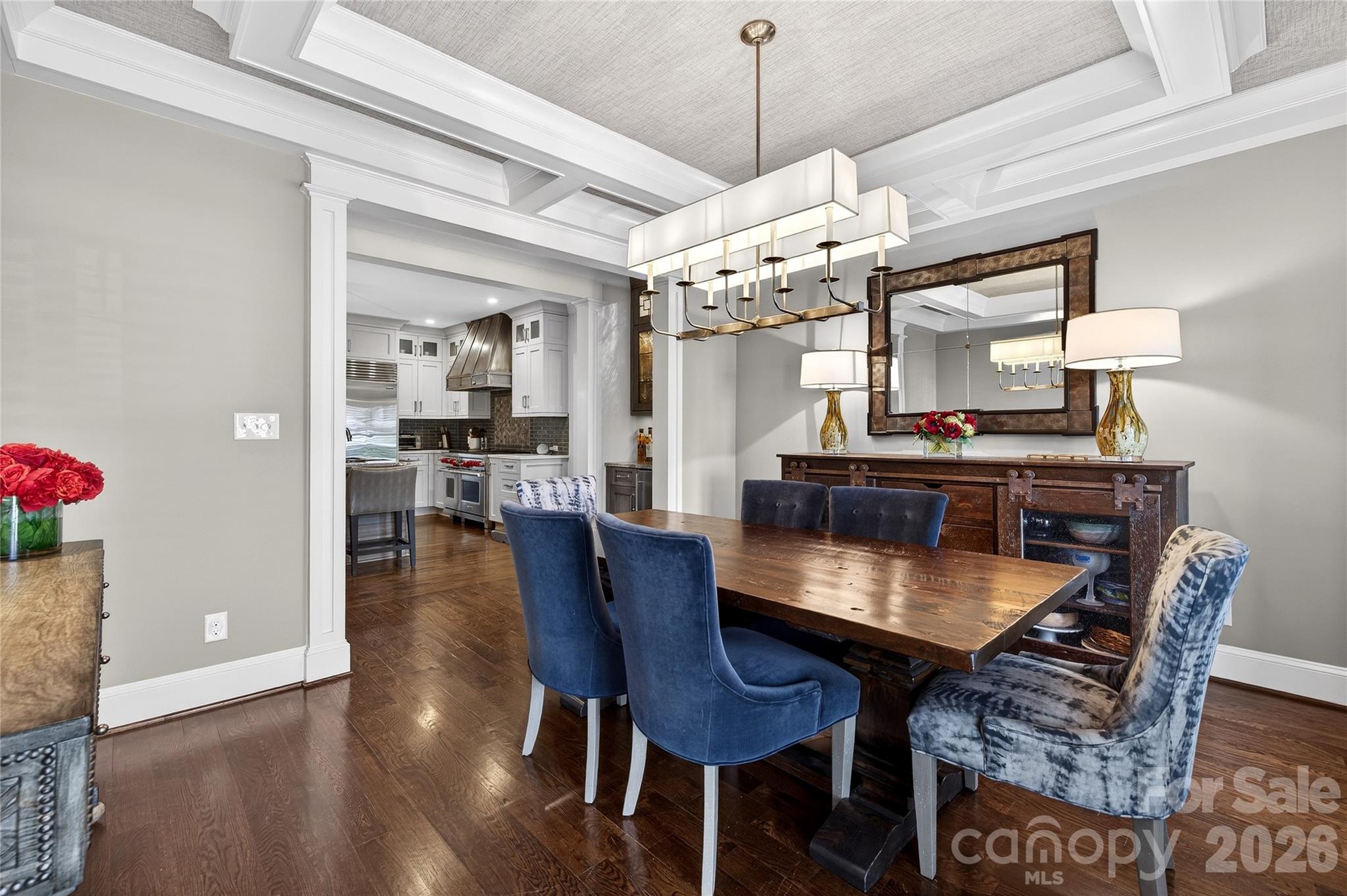3025 Foxridge Road Charlotte, NC 28226 - Photo 5 of 48 a dining room with furniture a chandelier and wooden floor