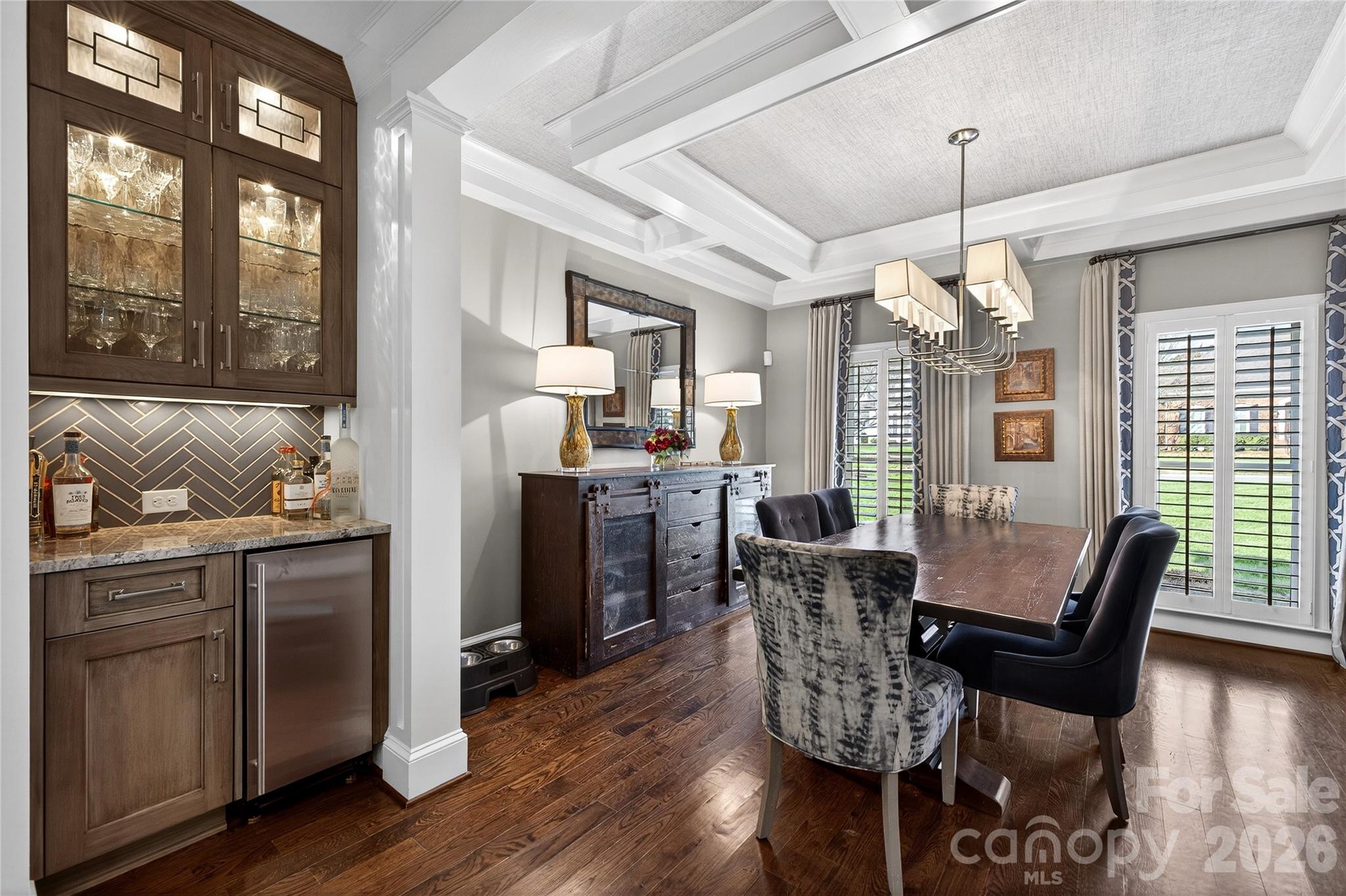 3025 Foxridge Road Charlotte, NC 28226 - Photo 8 of 48 a dining room with furniture a chandelier and wooden floor