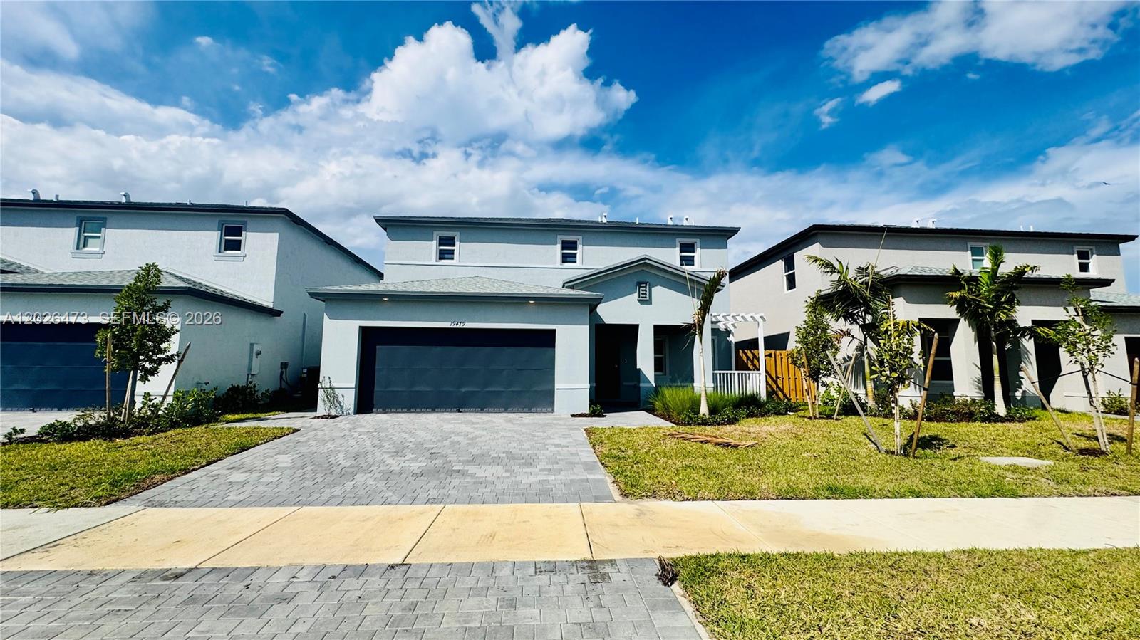 19479 Southwest 340th Street, Unit 1 Homestead, FL 33034 - Photo 2 of 58 a view of a white house with a yard