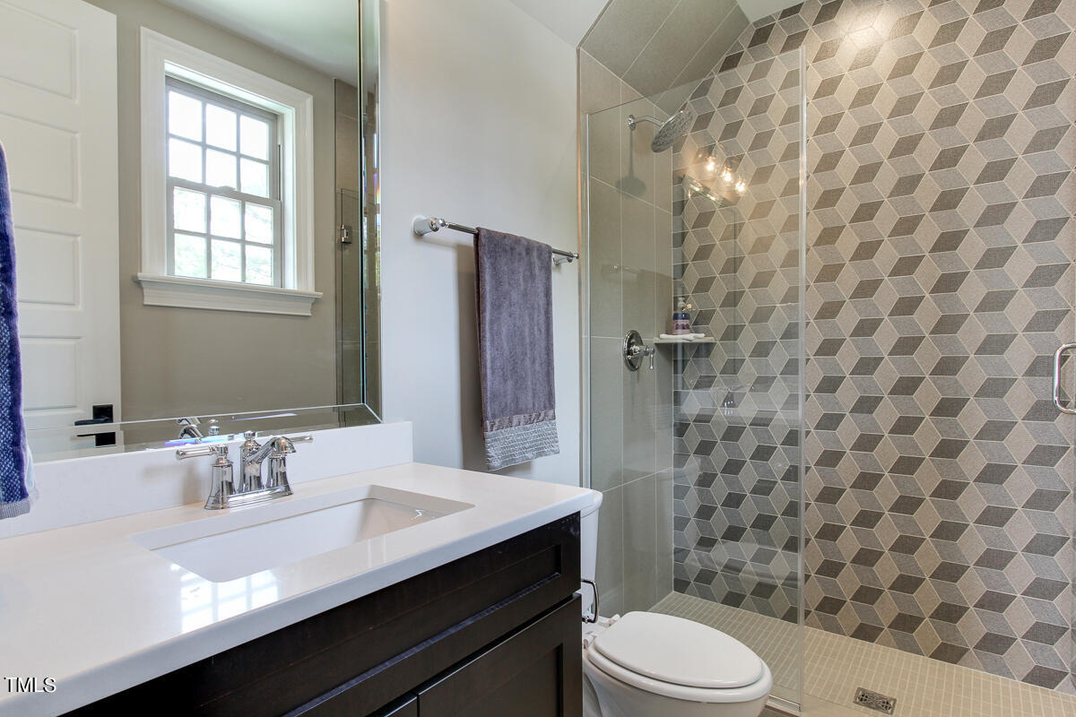 3311 Lake Boone Trail Raleigh, NC 27607 - Photo 12 of 24 a bathroom with a sink a toilet a shower and a mirror