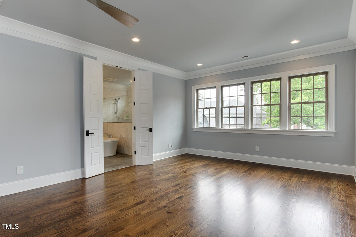 3311 Lake Boone Trail Raleigh, NC 27607 - Photo 14 of 24 an empty room with wooden floor and windows