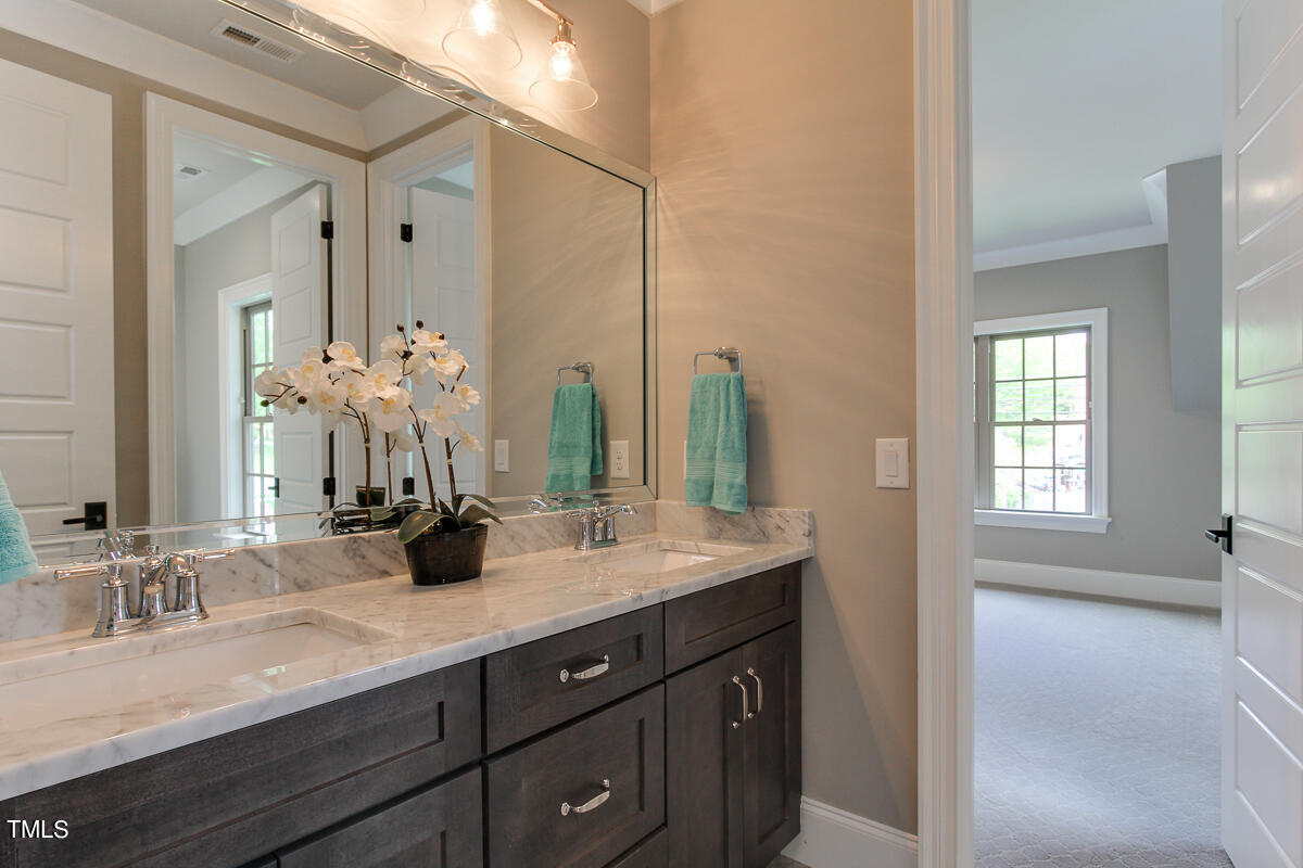 3311 Lake Boone Trail Raleigh, NC 27607 - Photo 19 of 24 a bathroom with double vanity sinks a vanity and a large mirror