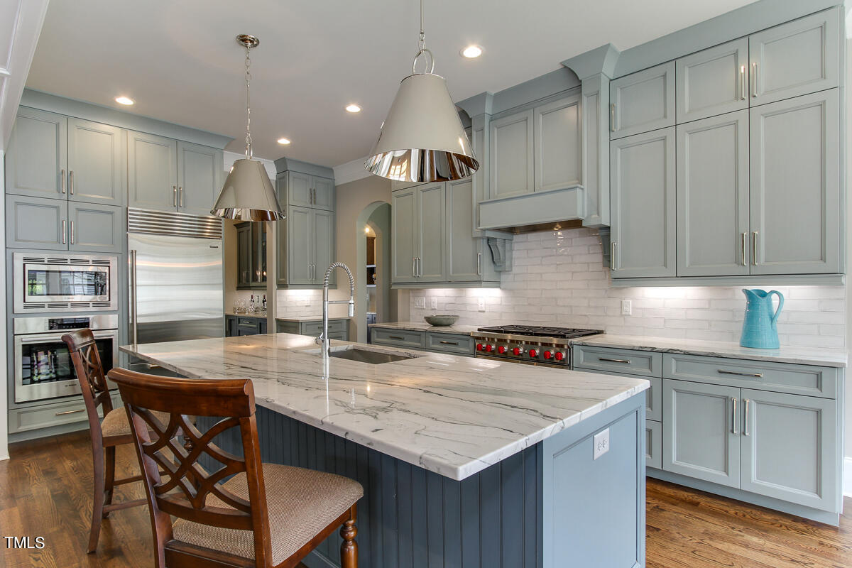 3311 Lake Boone Trail Raleigh, NC 27607 - Photo 7 of 24 a kitchen with granite countertop a table chairs stove and cabinets