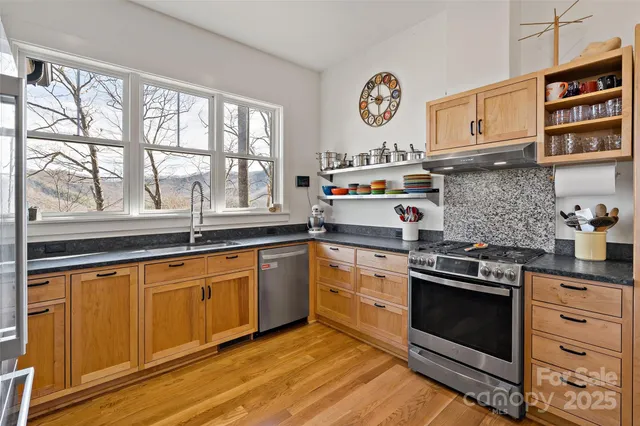 a kitchen with stainless steel appliances granite countertop a stove and a sink
