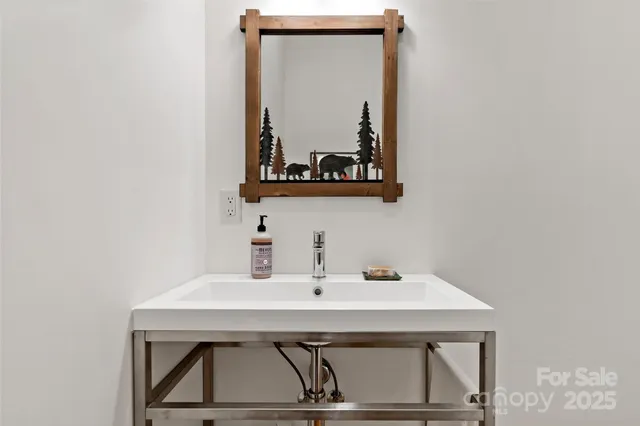 a bathroom with a sink and mirror