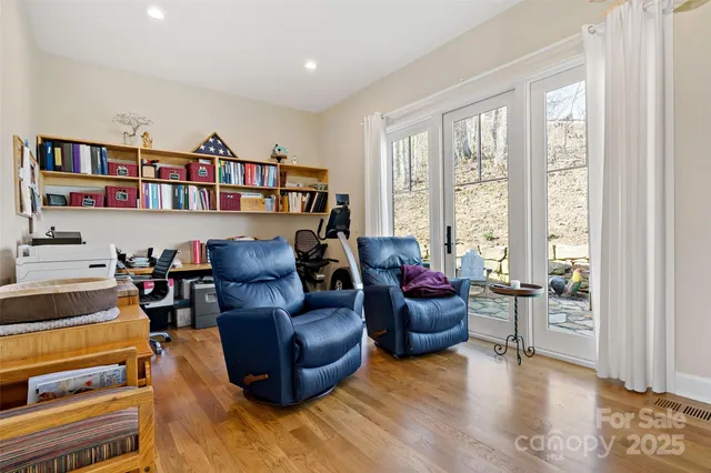 a living room with furniture and a book shelf