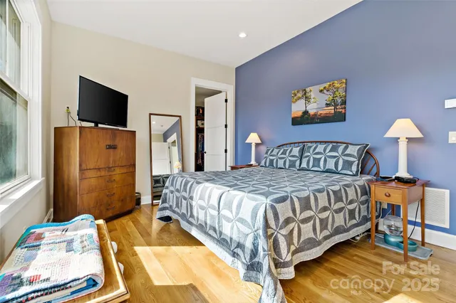 a bedroom with a bed and a flat screen tv