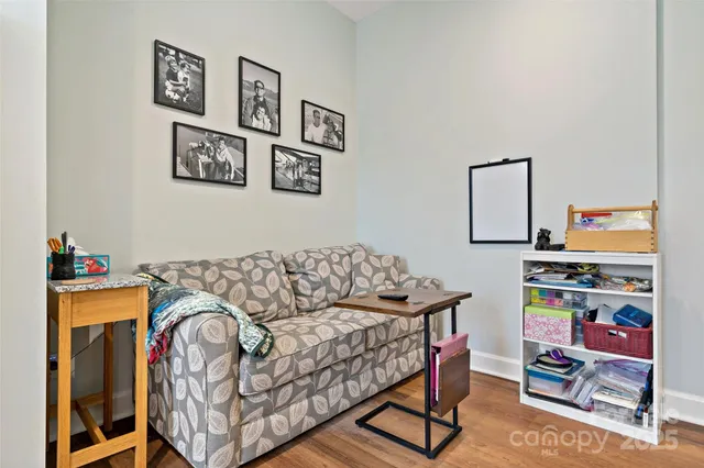 a living room with furniture cabinets and flat screen tv