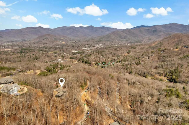 a view of a house with mountains in the background