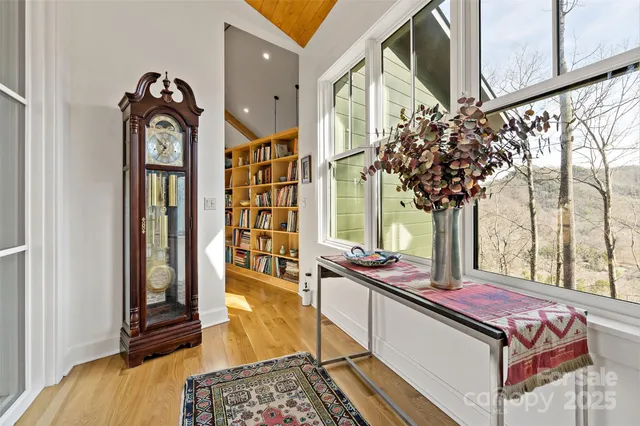 a living room with a bed furniture and a window