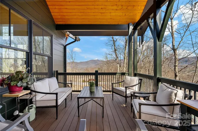 a view of a chairs and table in the balcony