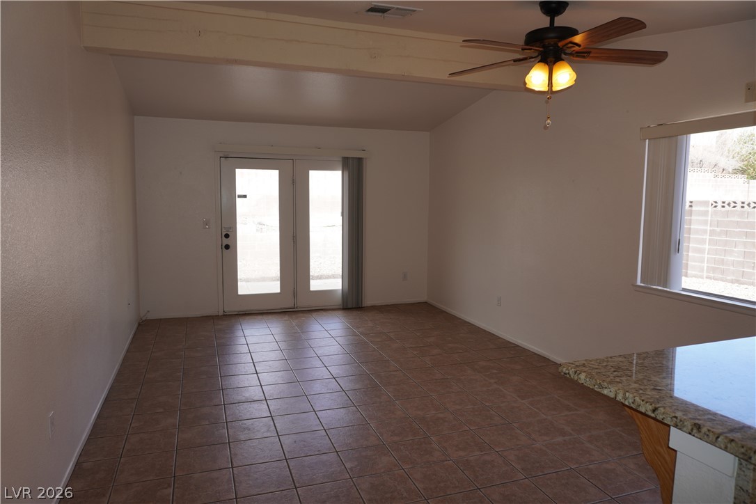 8328 Del Rey Avenue Las Vegas, NV 89117 - Photo 18 of 38 Natural light pours into this living area, featuring exposed beams and access to the outdoors.