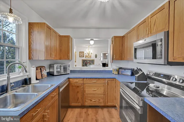 a kitchen with a sink stove top oven and cabinets