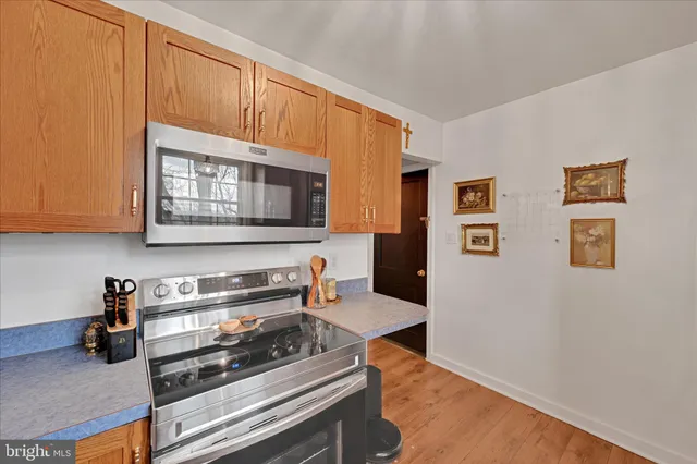 a kitchen with stainless steel appliances a stove microwave and cabinets