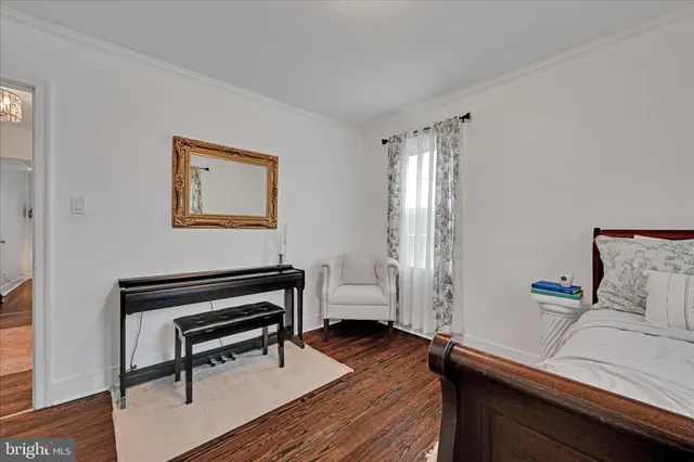 a bedroom with furniture and a wooden floor