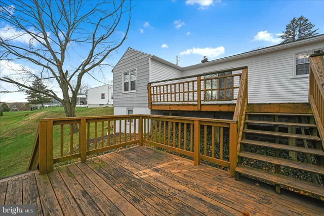 a large tree in front of a white house