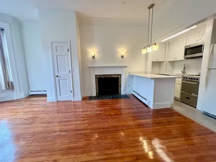 a view of a kitchen with a stove wooden floor kitchen view and a sink