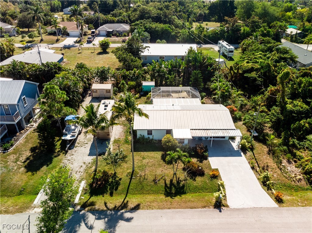 an aerial view of a residential houses with yard