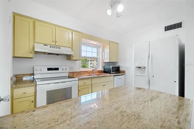 a kitchen with stainless steel appliances granite countertop a stove and a sink