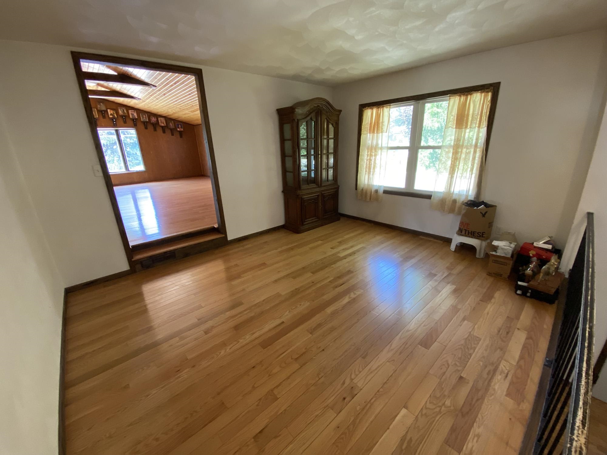 617 South Ridge Street Shannon, IL 61078 - Photo 14 of 30 an empty room with wooden floor and windows