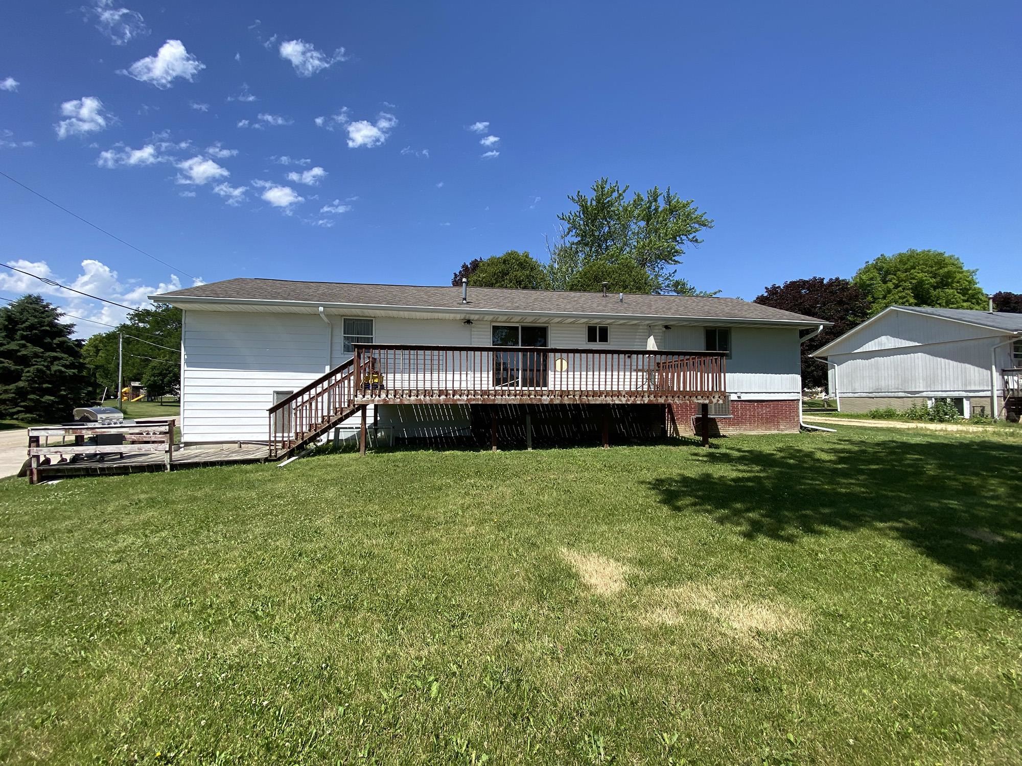 617 South Ridge Street Shannon, IL 61078 - Photo 4 of 30 a front view of a house with a garden and deck