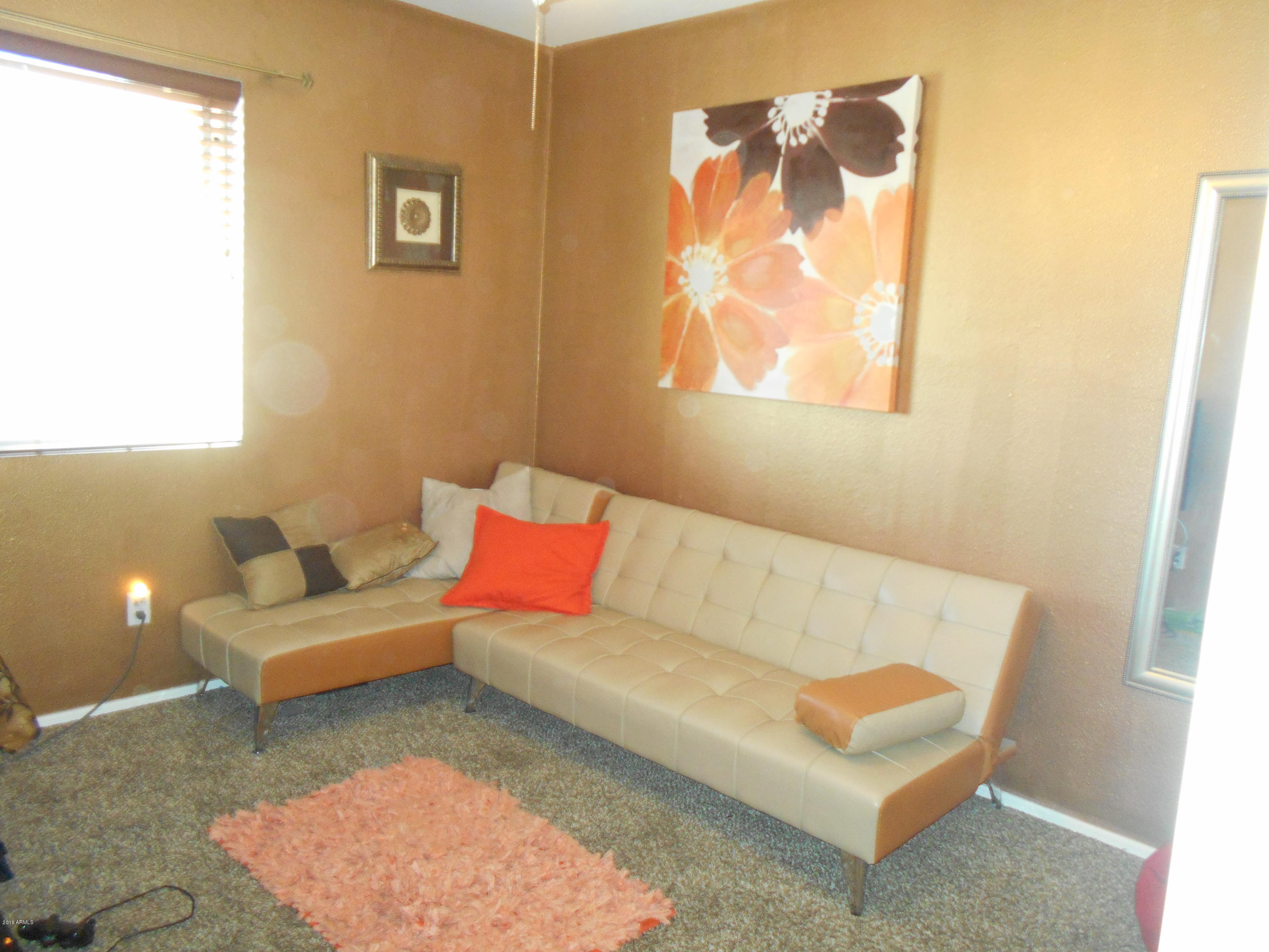 4902 West Tonto Road Glendale, AZ 85308 - Photo 12 of 22 a living room with furniture and a window