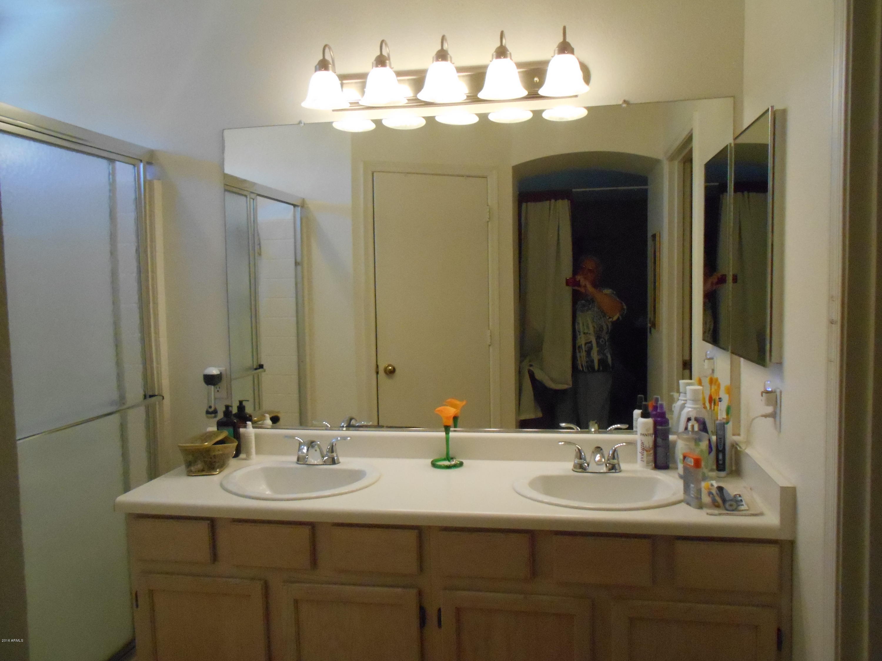 4902 West Tonto Road Glendale, AZ 85308 - Photo 14 of 22 a bathroom with double vanity sinks and a mirror