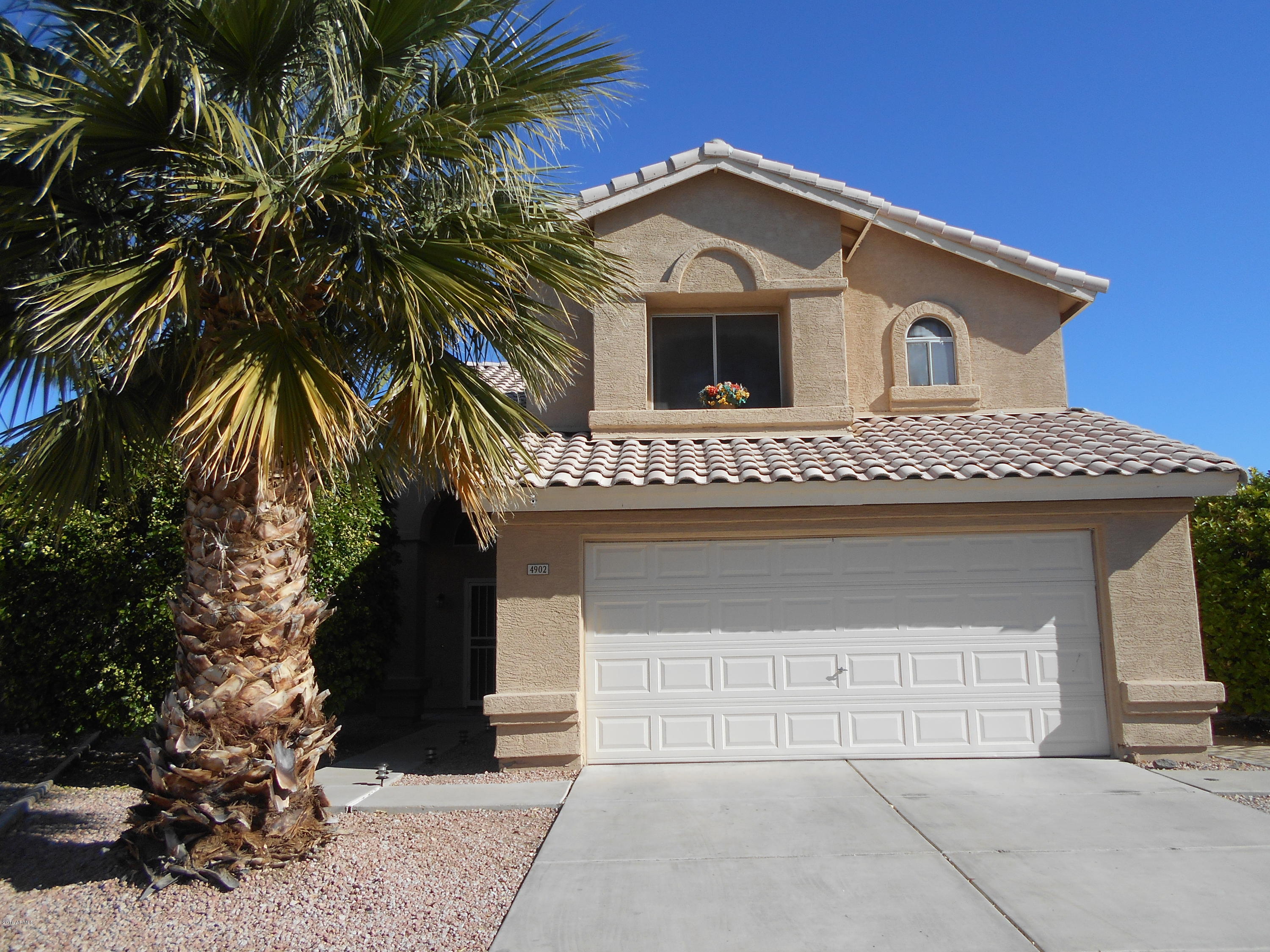 4902 West Tonto Road Glendale, AZ 85308 - Photo 2 of 22 a front view of a house with a garage