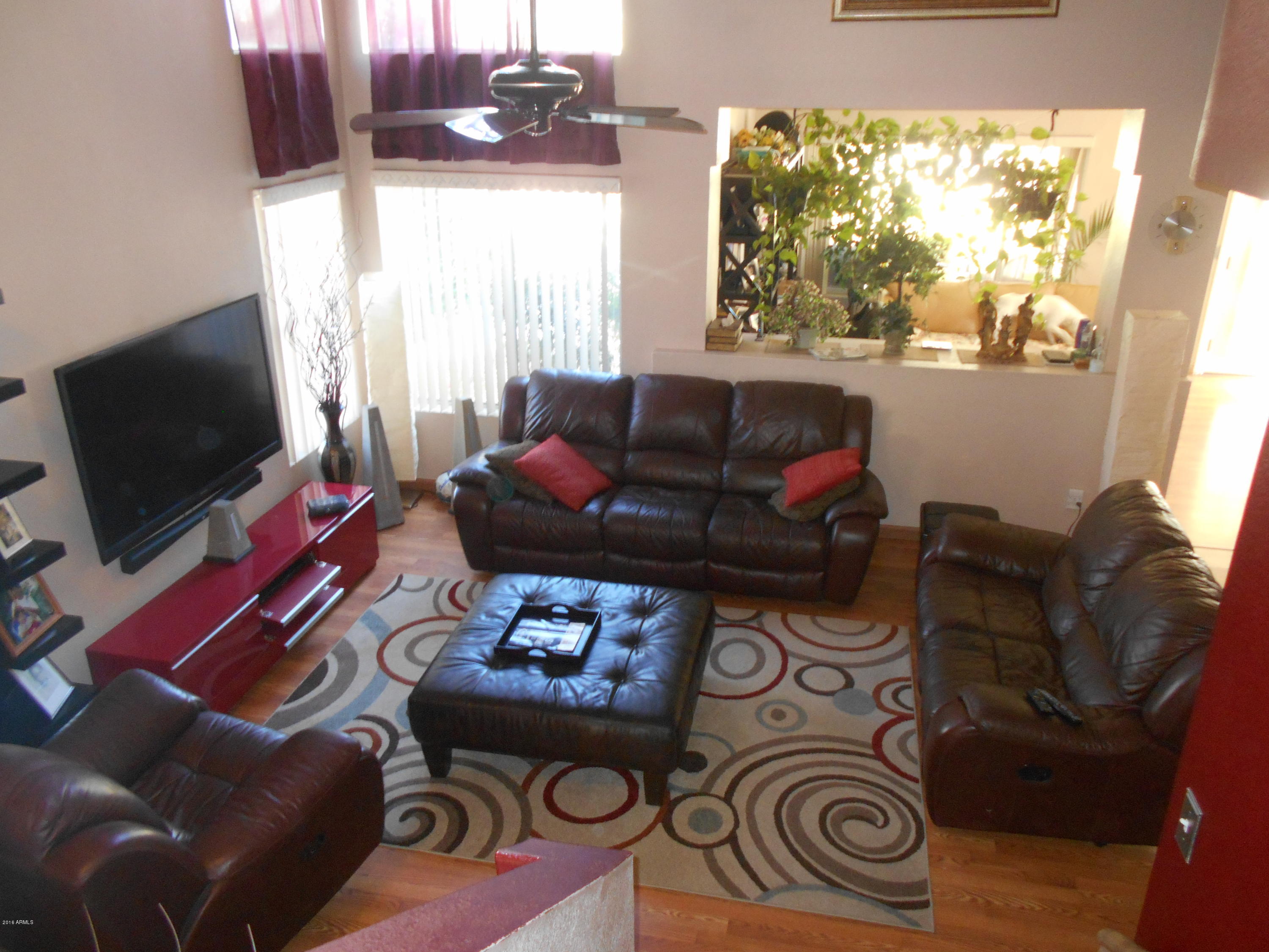 4902 West Tonto Road Glendale, AZ 85308 - Photo 4 of 22 a living room with furniture and a flat screen tv