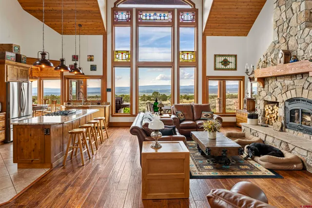 a very nice looking living room with a large window and kitchen view