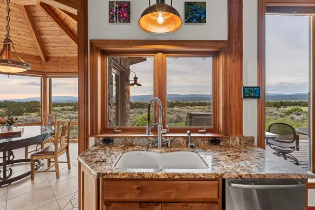 a dining table with chairs and window