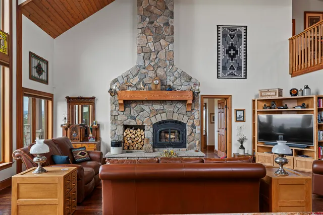 a living room with furniture a flat screen tv and a fireplace