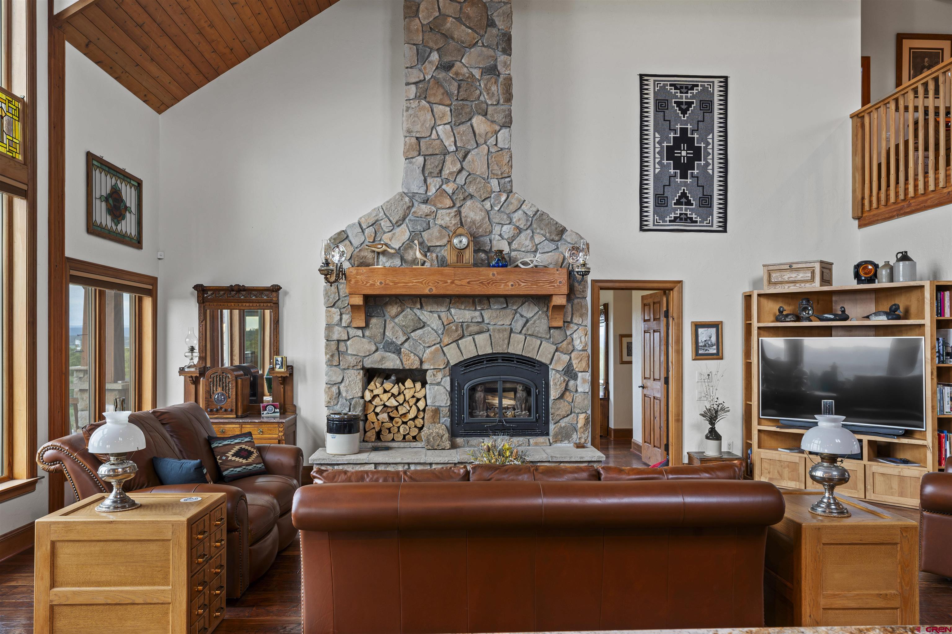 3100 South 44zs Road Norwood, CO 81423 - Photo 19 of 45 a living room with furniture a flat screen tv and a fireplace